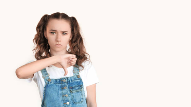 istock Refusal gesture nope sign skeptic girl thumbs down 2189279009