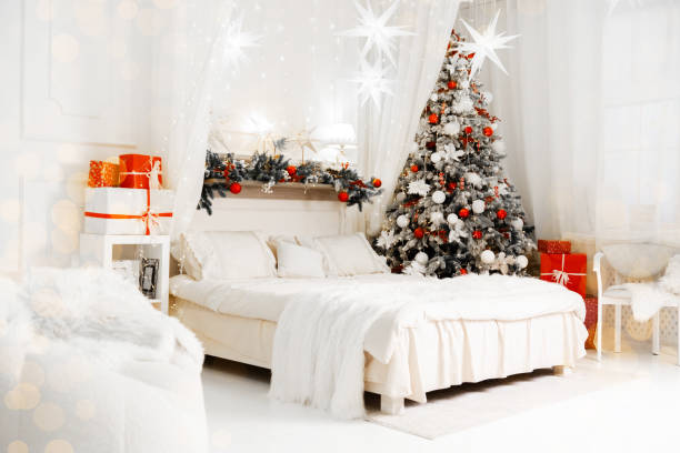 istock Festive winter bedroom with decorated Christmas tree and gift boxes 2189281066