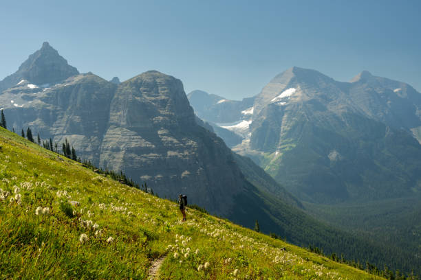 istock Backpacker Is Dwarfed By Her Surrounding In Glacier 2189298998