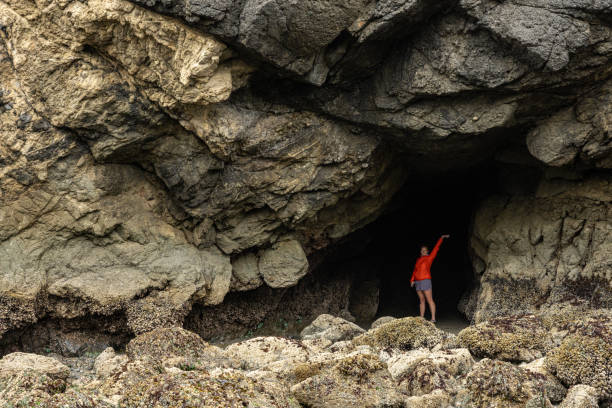 istock Woman Stands In Sea Cave At Low Tide 2189299766