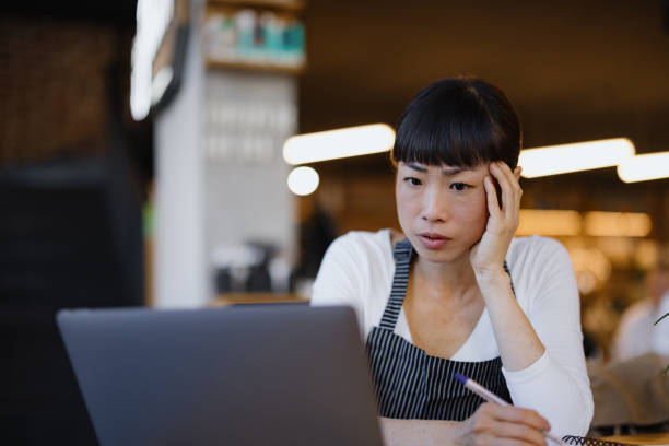 istock Focused Woman at Laptop in Coffee Shop Analyzing Work Tasks 2189302183