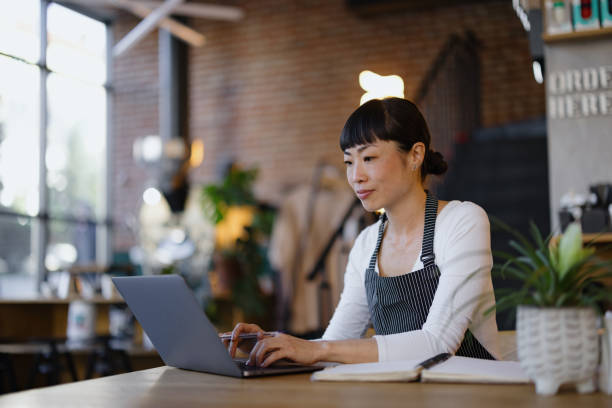istock Focused Barista Working on Laptop in Cozy Cafe Environment 2189302187