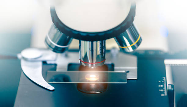 istock Close up of microscope with test sample in medical research lab or science laboratory. 2189302620