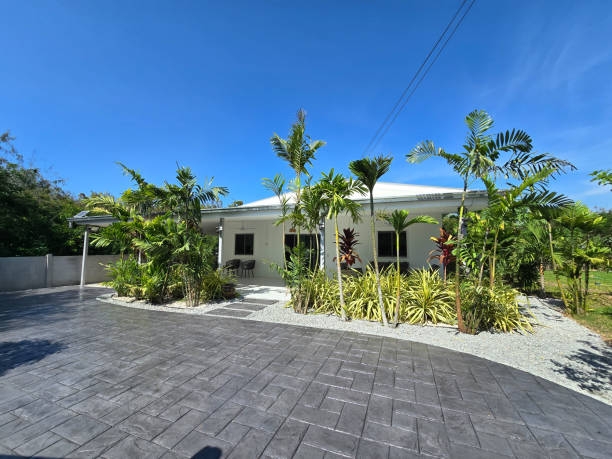 Stunning modern home with beautifully stamped concrete driveway in Pattaya, Thailand A vibrant modern home surrounded by lush greenery and tropical plants showcases a beautifully stamped concrete driveway. a Thai Suburban area with a modern family house Stamped Concrete Driveways.