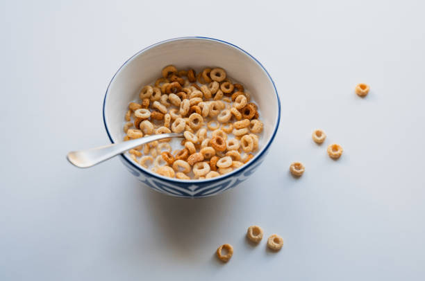 istock Bowl of cheerios breakfast cereal in milk on white background. 2189304004