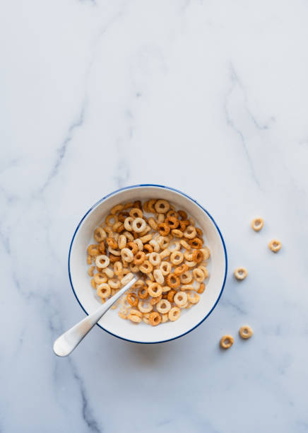 istock Bowl of cheerios breakfast cereal in milk on white background. 2189304016