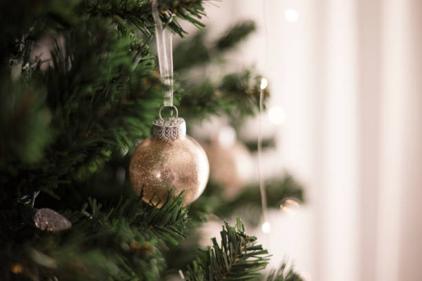 istock Close up of creme ornament hanging on christmas tree 2189304351