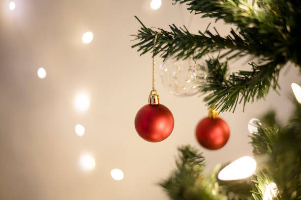 istock Close up of red ornaments hanging on a christmas tree 2189304411