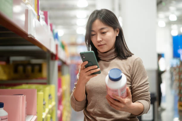 istock asian female using smart phone  in supermarket 2189307292