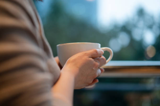istock asian female holding cup of coffee 2189308187