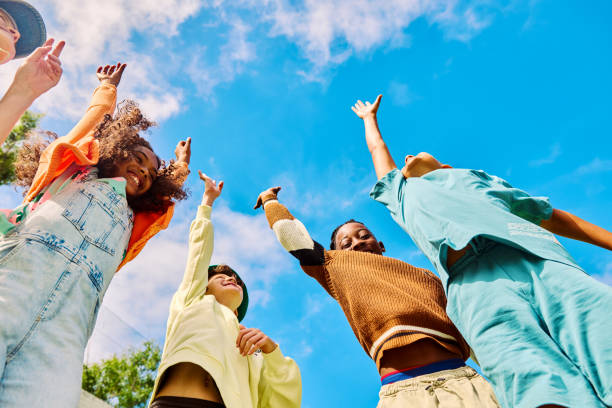 istock Happy multiethnic schoolkids raising hands outdoors on sunny day 2189309879