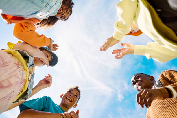 Hands  group  people who stay together in a circle against the background of the blue sky