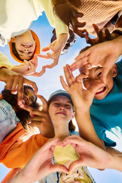 istock Diverse group of school kids making heart shapes with hands 2189309894