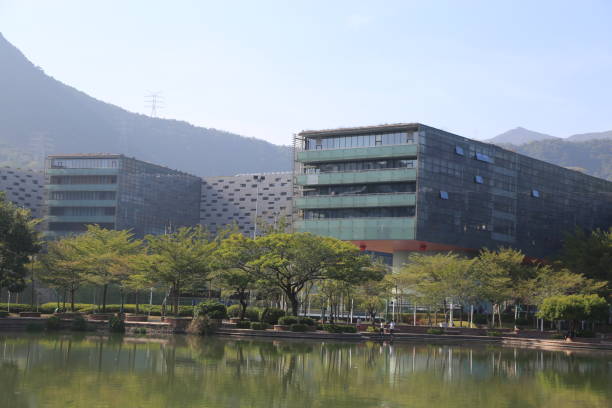 A large building with a green roof sits on a hillside