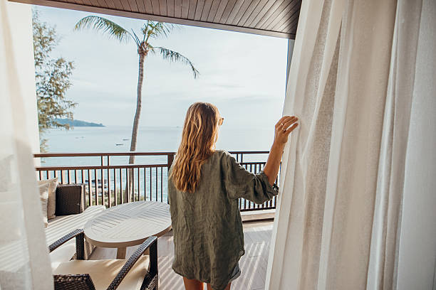 istock Woman Enjoying Ocean View from Balcony 2189314159