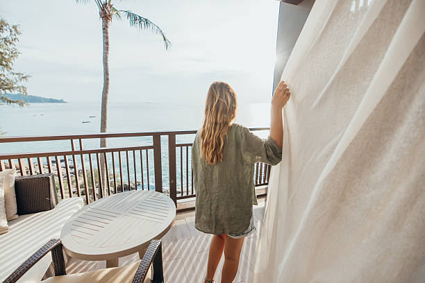 istock Woman Enjoying Ocean View from Balcony 2189314186