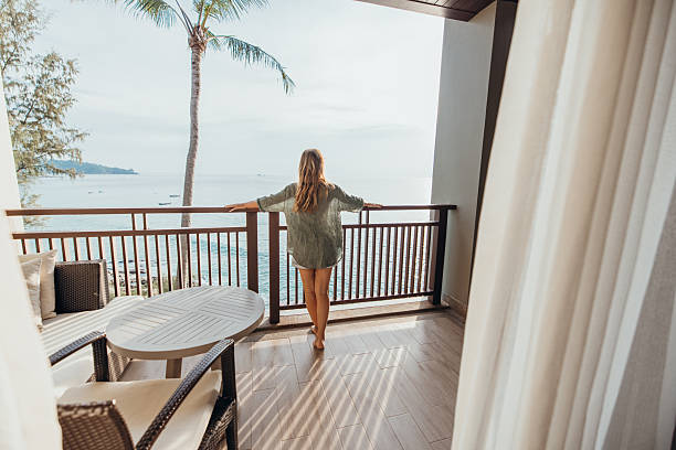 istock Woman Relaxing on Balcony Overlooking Ocean View 2189314273
