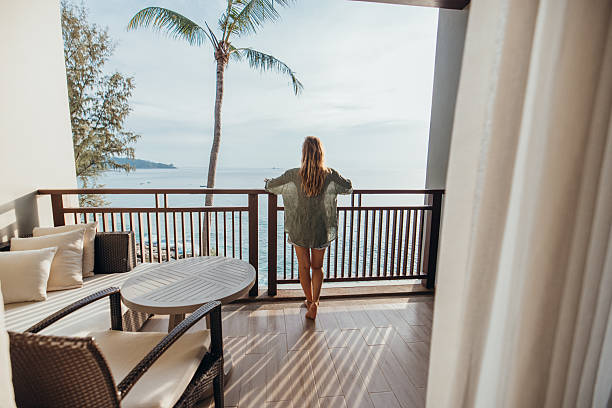 istock Woman Relaxing on Balcony Overlooking Ocean View 2189314378