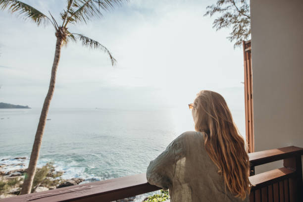 istock Woman Enjoying Ocean View from Balcony 2189314455