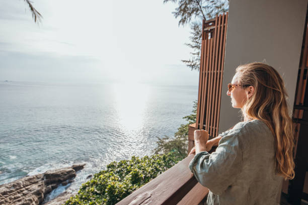 istock Woman Enjoying Ocean View from Balcony 2189314457
