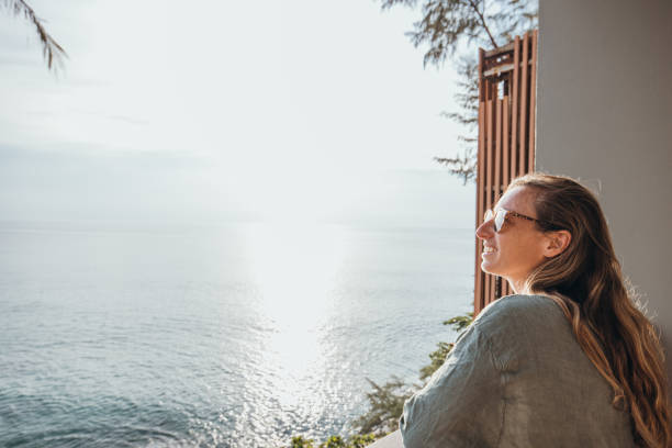 istock Woman Enjoying Ocean View from Balcony 2189314458