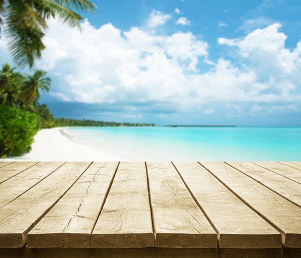 istock Empty wooden table top with beautiful tropical paradise island background 2189314951