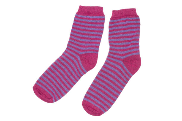A pair of warm striped socks isolated on a white background. Red wool socks close-up.
