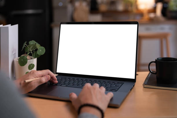 istock Close-up image of a man working on laptop computer at a table, typing on the laptop keyboard. the laptop with a white screen mockup 2189322968