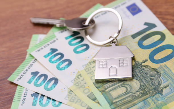 istock House key symbol pendant on one hundred euro banknotes 2189326366
