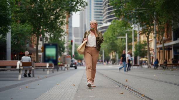 Businesswoman Using AI Chatbot While Walking in City