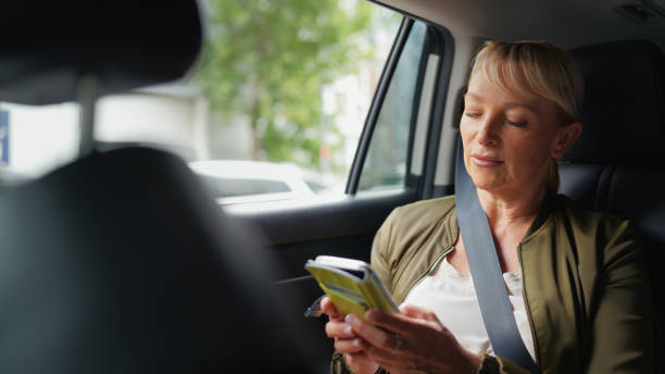 istock Businesswoman Using Smart Phone During Car Ride 2189331267