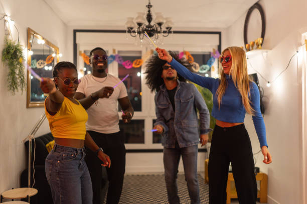 istock Young multiethnic friends group dancing with glow sticks at home party 2189333365