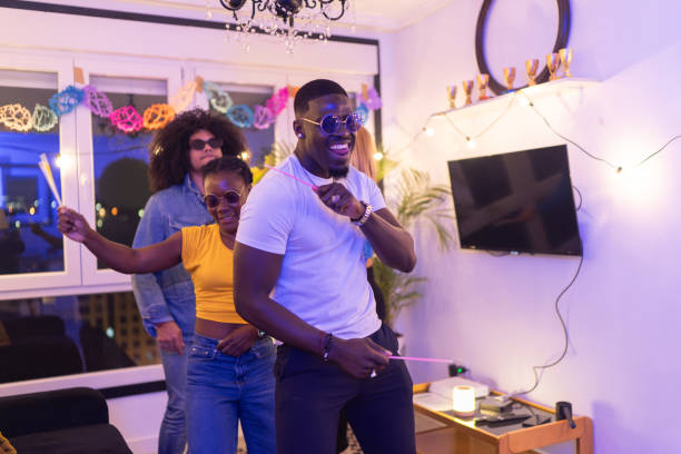 istock Friends dancing together at home party 2189333437