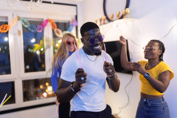 istock Happy multiethnic friends dancing together at home party 2189333500