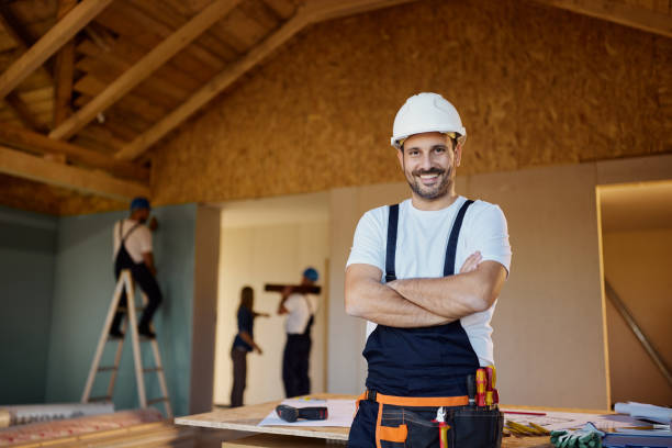 istock Happy male worker with crossed arms at construction site. 2189333668