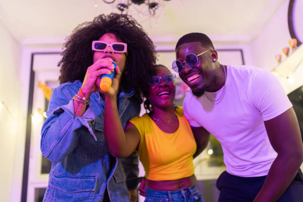 istock Young friends singing karaoke at home party 2189333683
