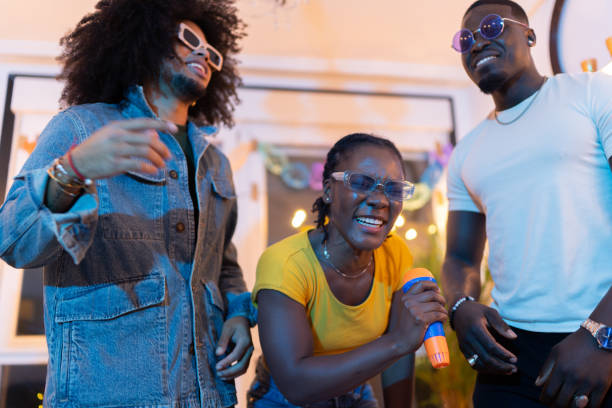 istock Young friends singing karaoke at home party 2189333704