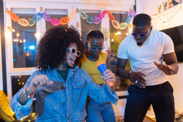 istock Friends singing karaoke and dancing at home party 2189333716