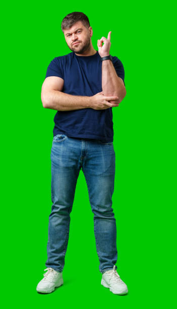 istock A man thoughtfully ponders on a bright green background 2189333727