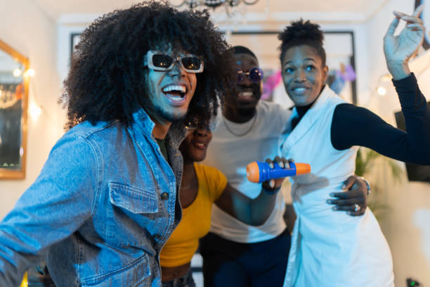 istock Young people singing karaoke at home party 2189333825