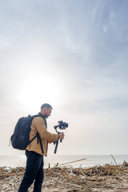 istock Videographer captures aftermath of storm, filming debris and pollution on beach 2189335124