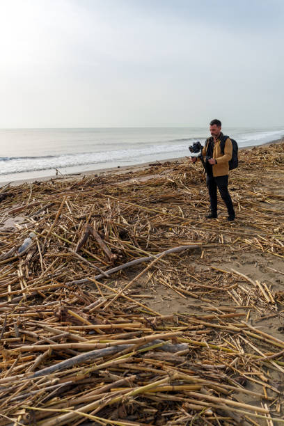 Videographer captures footage of debris on beach after flood