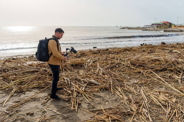 istock Videographer captures the aftermath of a beach flood, documenting the debris washed up on the shore 2189335162