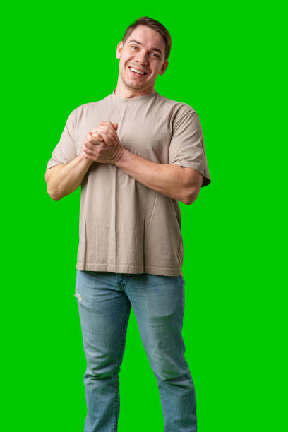 istock A cheerful man with a friendly smile poses against a bright green background 2189335891