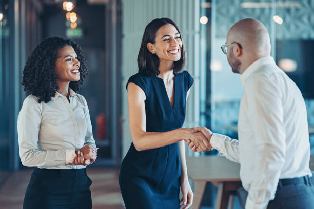 istock Smiling businesswoman greeting a visitor 2189337419