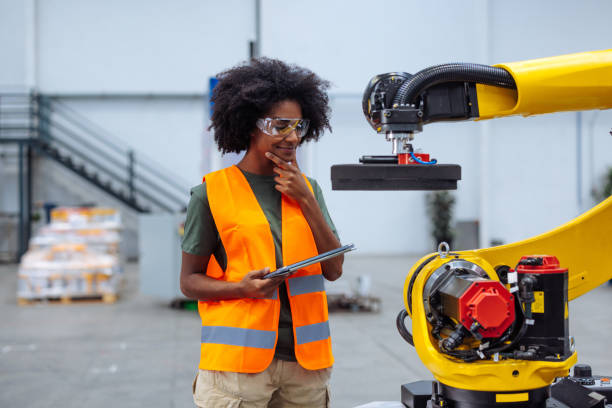 istock Female engineer controlling robotic arm in factory 2189337554