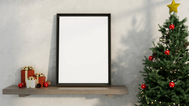 istock A blank frame on a wooden shelf against a white wall, with a glowing Christmas tree beside it. 2189337643