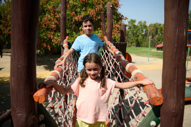 istock Children having fun on a rope bridge at an outdoor playground 2189337952