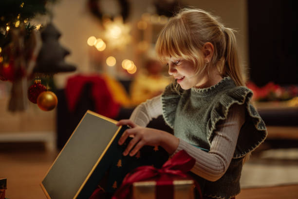 istock Excited girl opening a Christmas present 2189338162
