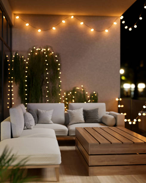 istock A cozy, beautiful apartment balcony at night, featuring a comfortable couch and glowing lights. 2189338264